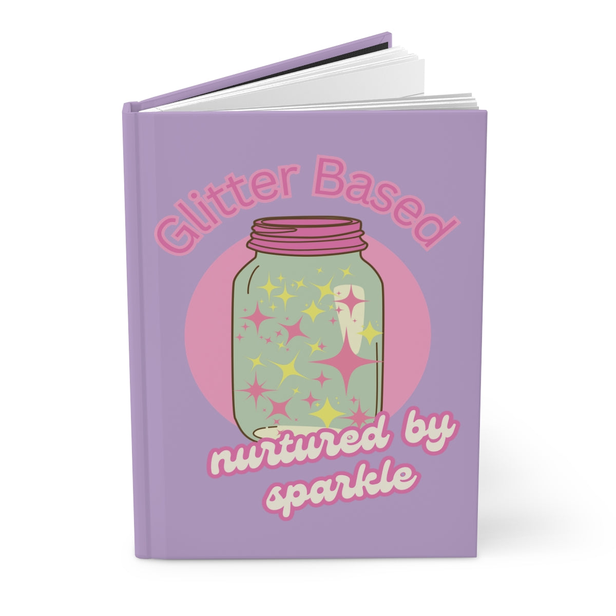Open pastel purple color hardcover journal with featuring an illustration of a retro style mason jar with pink lid filled with pastel colored glitter and text "glitter based nurtured by sparkle" written in pink retro aesthetic letters