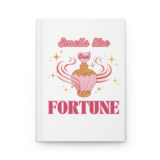 Notebook with a pink vintage perfume bottle design with oud scent and pastel pink retro groovy aesthetic 'Smells like Fortune' text on a white background