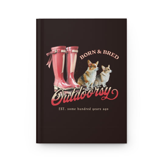 Hardcover brown notebook with red Wellington boots and Corgi dogs design that has texts "born & bred", "outdoorsy" 