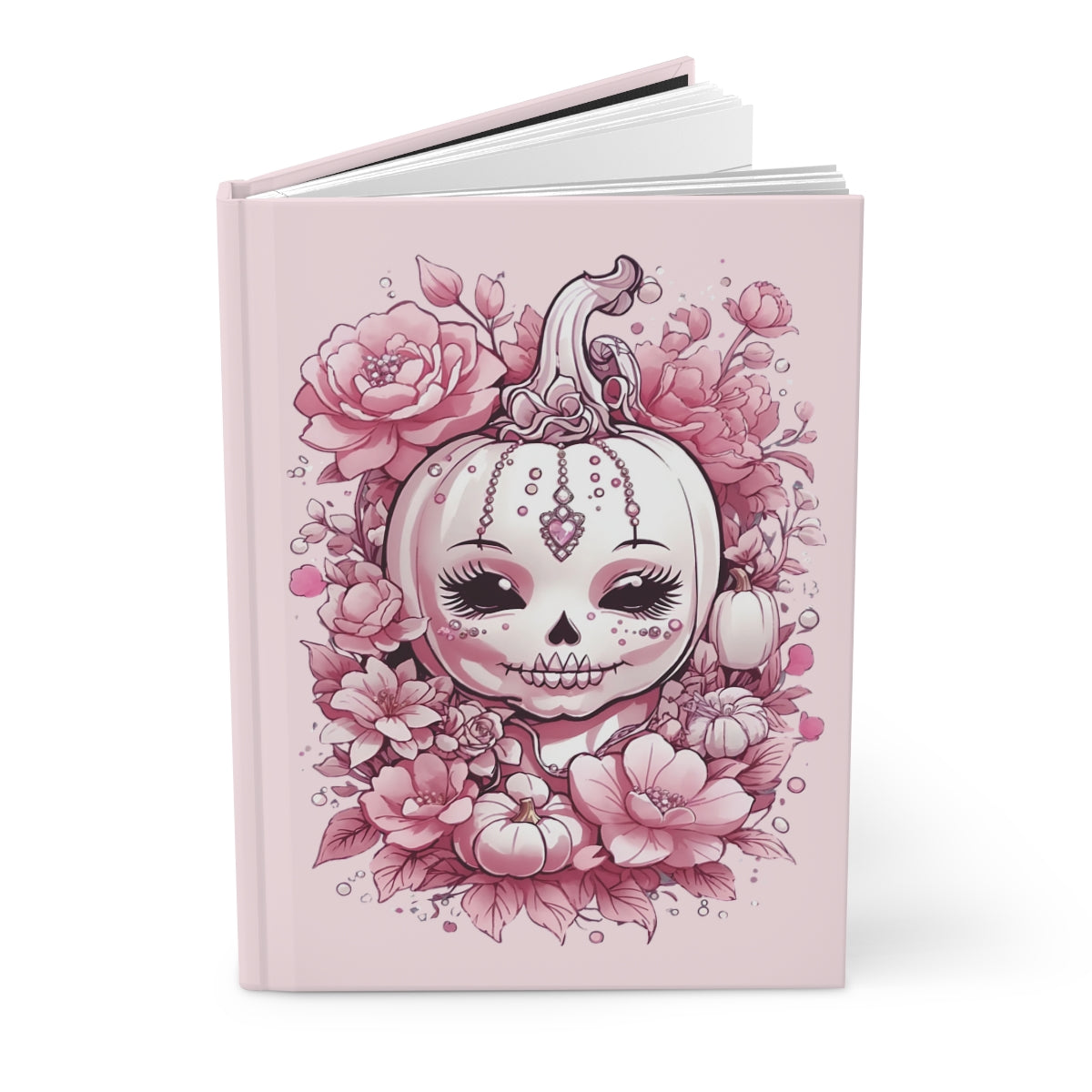 Notebook with a pink halloween pumpkin and floral design on a pastel pink background