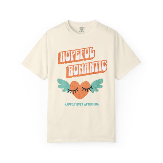 Beige t-shirt with 'Hopeful Romantic' text in retro aesthetic letters, and an orange heart design and "happily ever after era" text