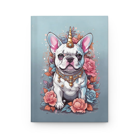 notebook with an Illustration of a kawaii style French bulldog wearing a unicorn horn and a necklace, surrounded by pastel colored flowers on a light blue background