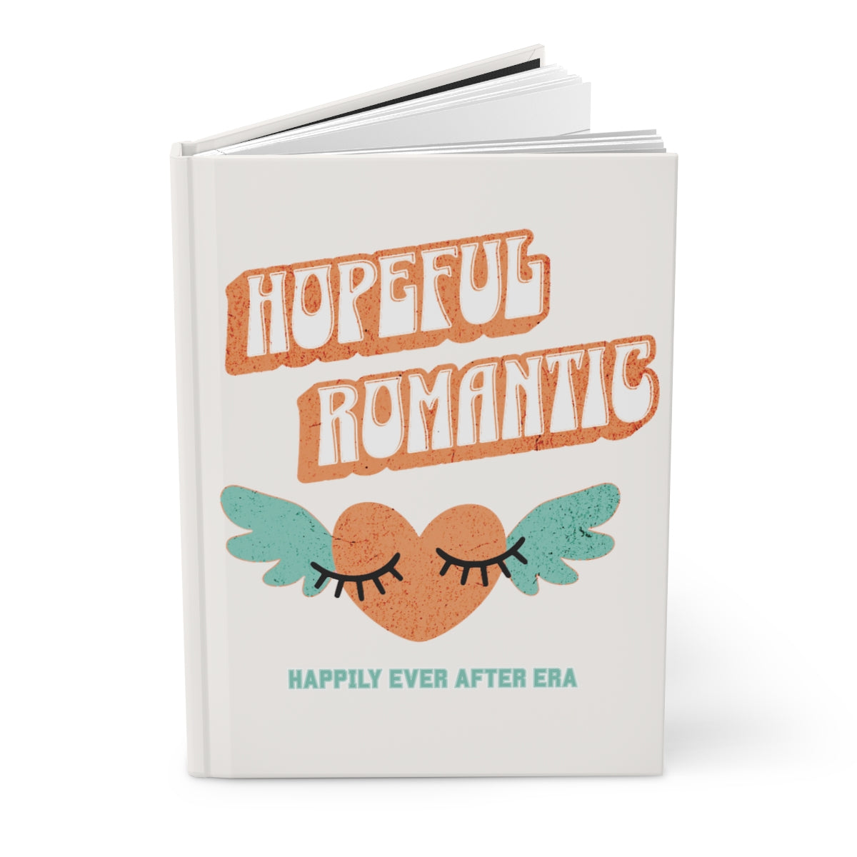 Notebook with an orange retro fashion text that says "hopeful romantic" and an orange heart with mint green wings and a text "happily ever after era" underneath