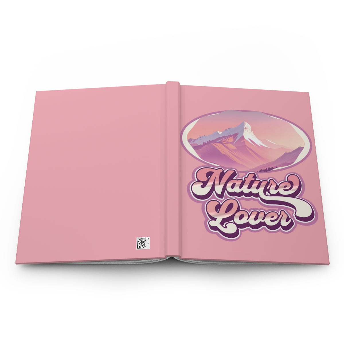Open notebook with pastel pink cover featuring a pink mountain graphic and 'Nature Lover' text written with retro groovy font in pink and purple