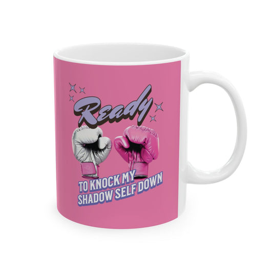 Hot Pink mug with pink boxing gloves and a light purple text that says "ready to knock my shadow self down" in retro style letters