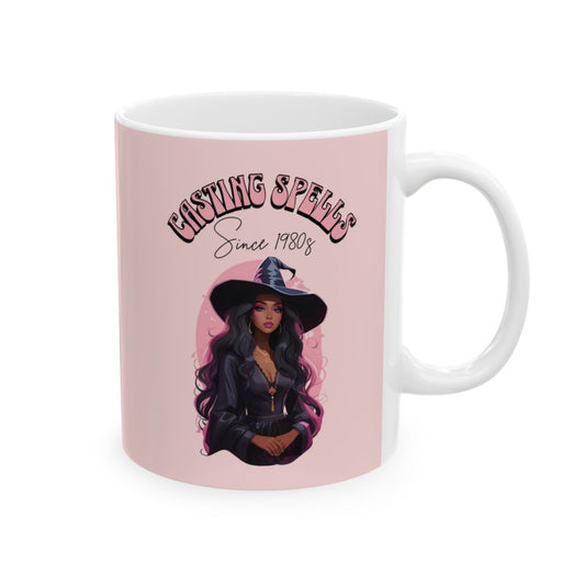 Light Pink mug with a beautiful black witch graphic and text 'Casting Spells Since 1980s' written in retro groovy style pink letters on a soft pink background