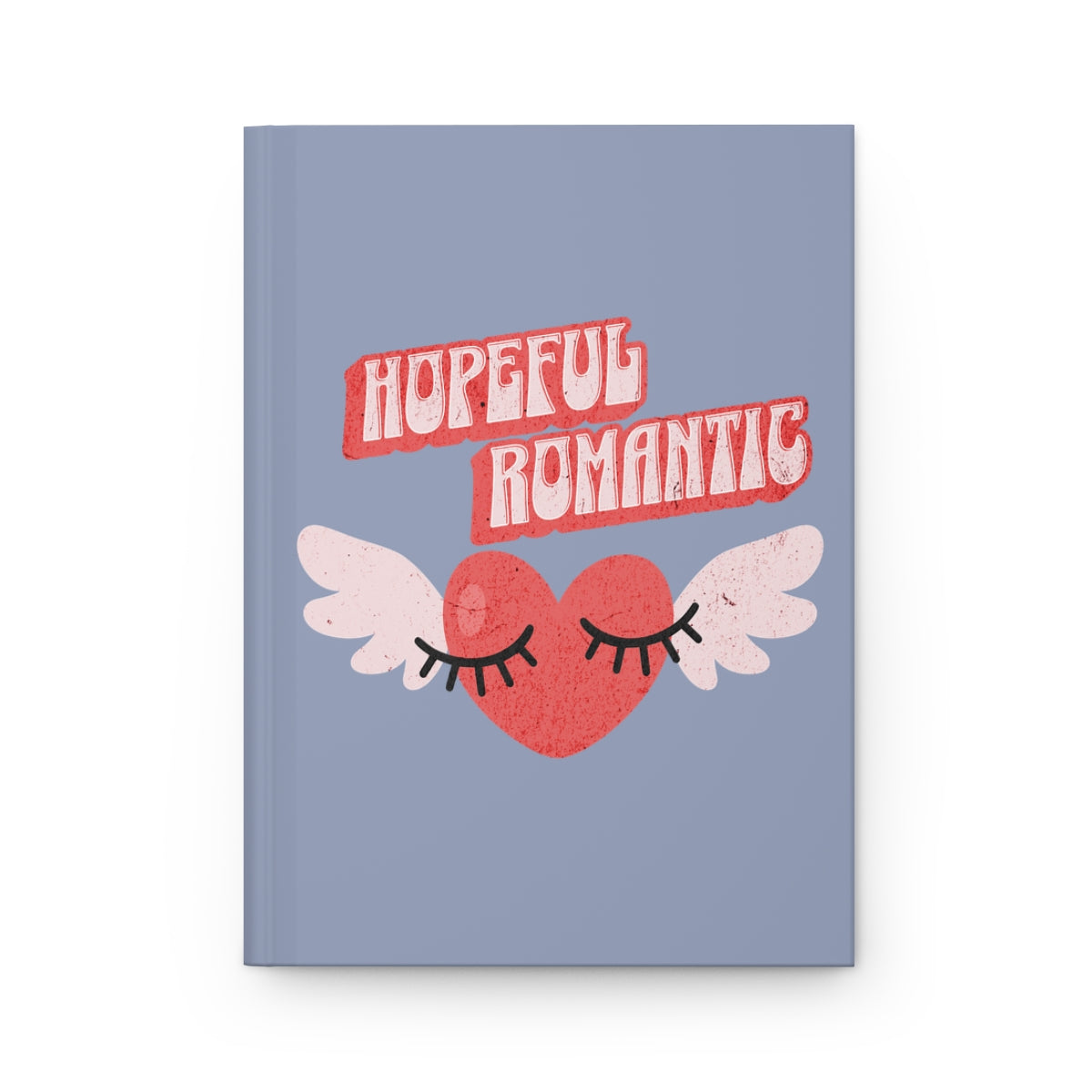 Notebook with a retro style red heart with wings and flirty eyelashes design and 'Hopeful Romantic' text written in retro aesthetic font, on a light blue jean colored background