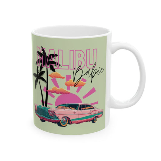 pastel colored Mug with 'Malibu Babie' text and a design featuring a pink convertible car, palm trees, pink sun, set in golden hour