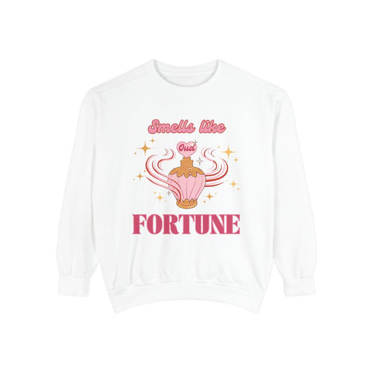 White sweatshirt with a pastel pink oud perfume bottle  graphic design and text that says "smells like fortune"
